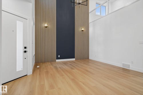 Foyer featuring a high ceiling, wood finished floors, and hanging lights - 3508 6 Street, Edmonton, AB - Indoor Photo Showing Other Room