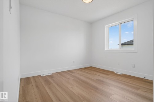 Unfurnished room with baseboards and light wood-type flooring - 3508 6 Street, Edmonton, AB - Indoor Photo Showing Other Room