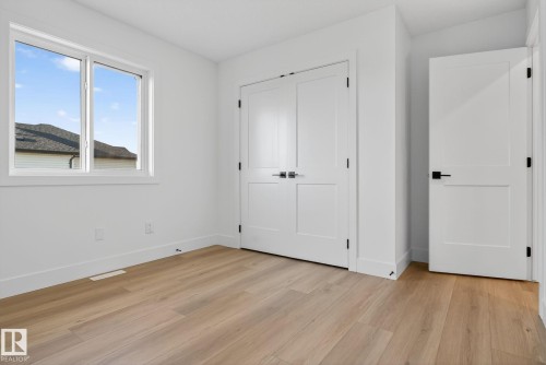 Unfurnished bedroom with light wood-style floors and a closet - 3508 6 Street, Edmonton, AB - Indoor Photo Showing Other Room
