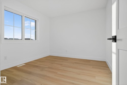 Empty room with light wood-type flooring and baseboards - 3508 6 Street, Edmonton, AB - Indoor Photo Showing Other Room