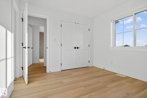 Unfurnished bedroom with light wood-style floors and a closet - 3508 6 Street, Edmonton, AB - Indoor Photo Showing Other Room