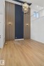 Unfurnished dining area with a high ceiling, light wood finished floors, and suspended lighting - 3508 6 Street, Edmonton, AB  - Indoor Photo Showing Other Room 
