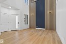 Foyer entrance with a high ceiling, light wood-style flooring, and hanging lights - 3508 6 Street, Edmonton, AB  - Indoor Photo Showing Other Room 