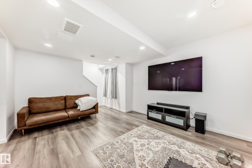 Living area with light wood finished floors and recessed lighting - 1002 Stillwater Boulevard, Edmonton, AB - Indoor Photo Showing Living Room