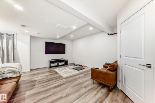 Living room with light wood-style flooring and recessed lighting - 1002 Stillwater Boulevard, Edmonton, AB - Indoor