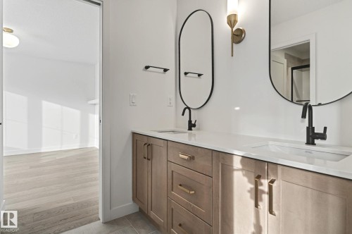 Bathroom with double vanity and light wood-style flooring - 58 Redpoll Wynd, St. Albert, AB - Indoor Photo Showing Bathroom