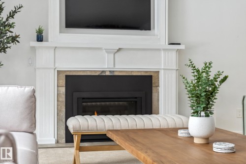 Detailed view of a tiled fireplace - 14018 100 Avenue, Edmonton, AB - Indoor Photo Showing Living Room With Fireplace