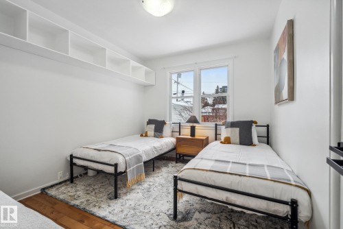 Bedroom with wood-type flooring and baseboards - 14018 100 Avenue, Edmonton, AB - Indoor Photo Showing Bedroom