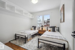 Bedroom with wood-type flooring and baseboards - 