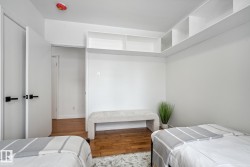 Bedroom with wood-type flooring and baseboards - 