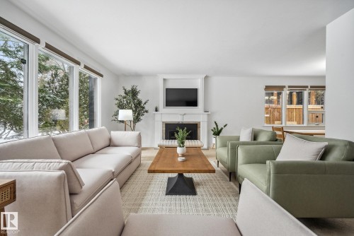 Living room with a fireplace and healthy amount of natural light - 14018 100 Avenue, Edmonton, AB - Indoor Photo Showing Living Room With Fireplace