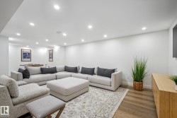 Living room with recessed lighting and dark wood finished floors - 