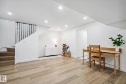 Office space with light wood-type flooring and recessed lighting - 