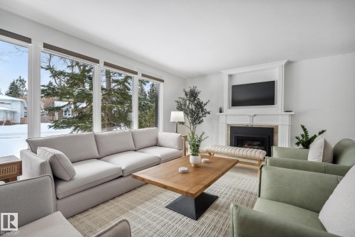 Living area featuring a glass covered fireplace - 14018 100 Avenue, Edmonton, AB - Indoor Photo Showing Living Room With Fireplace