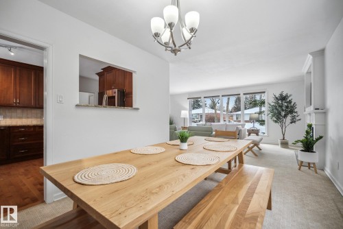 Dining room with suspended lighting and light colored carpet - 14018 100 Avenue, Edmonton, AB - Indoor Photo Showing Dining Room