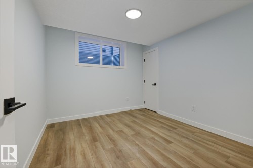 Empty room featuring light wood finished floors and baseboards - 9627 152 Street Nw, Edmonton, AB - Indoor Photo Showing Other Room