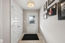 Doorway to outside featuring baseboards - 