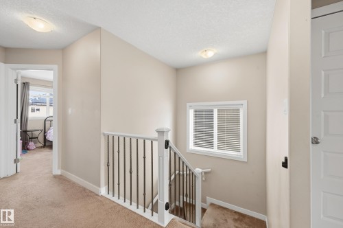 Hallway with an upstairs landing, a textured ceiling, and carpet flooring - 5978 167C Avenue, Edmonton, AB - Indoor Photo Showing Other Room