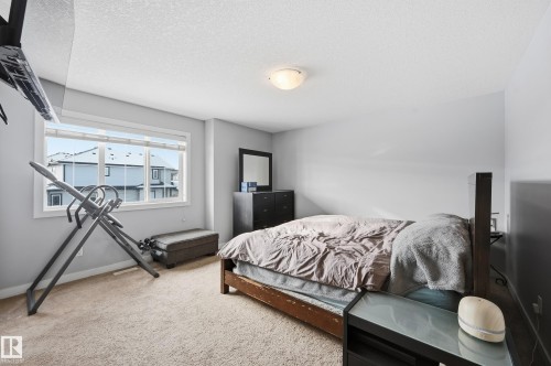 Carpeted bedroom with baseboards and a textured ceiling - 5978 167C Avenue, Edmonton, AB - Indoor Photo Showing Bedroom