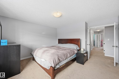 Bedroom with light colored carpet and a textured ceiling - 5978 167C Avenue, Edmonton, AB - Indoor Photo Showing Bedroom