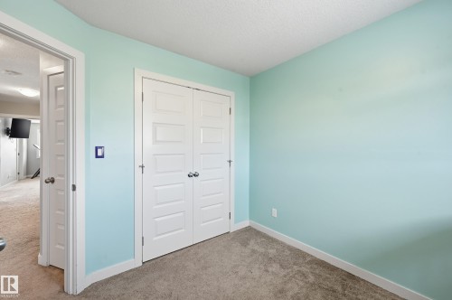 Unfurnished bedroom featuring carpet floors, a textured ceiling, and a closet - 5978 167C Avenue, Edmonton, AB - Indoor Photo Showing Other Room