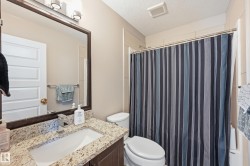Bathroom with a shower with curtain, vanity, and a textured ceiling - 