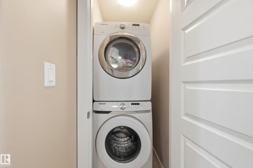 Laundry area featuring stacked washer / drying machine - 5978 167C Avenue, Edmonton, AB - Indoor Photo Showing Laundry Room
