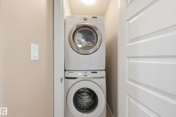 Laundry area featuring stacked washer / drying machine - 