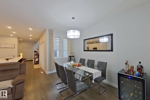 Dining room featuring beverage cooler, dark wood-type flooring, and recessed lighting - 4419 Kinsella Green, Edmonton, AB - Indoor Photo Showing Dining Room