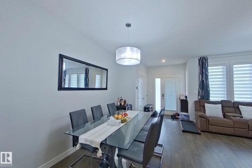 Dining area with dark wood-style flooring and recessed lighting - 4419 Kinsella Green, Edmonton, AB - Indoor Photo Showing Dining Room