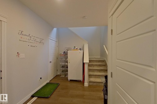 Hallway with light wood-style floors and stairs - 4419 Kinsella Green, Edmonton, AB - Indoor Photo Showing Other Room