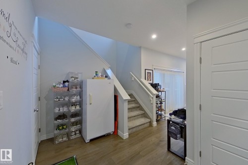 Stairs with wood finished floors and recessed lighting - 4419 Kinsella Green, Edmonton, AB - Indoor Photo Showing Other Room