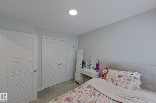 Bedroom featuring a closet and light colored carpet - 4419 Kinsella Green, Edmonton, AB - Indoor Photo Showing Bedroom