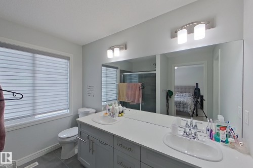Bathroom featuring double vanity, ensuite bathroom, and a stall shower - 4419 Kinsella Green, Edmonton, AB - Indoor Photo Showing Bathroom