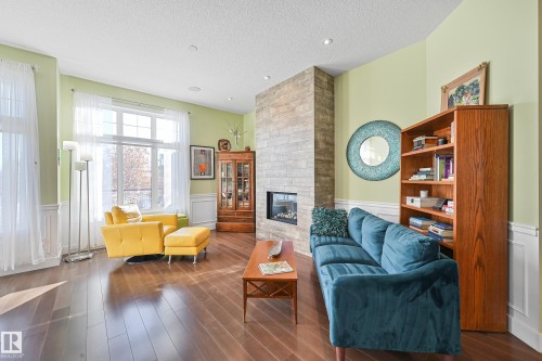 1 7570 May Common, Edmonton, AB - Indoor Photo Showing Living Room With Fireplace
