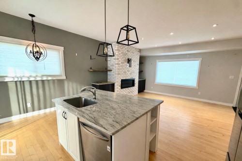 6 Manor Drive, Spruce Grove, AB - Indoor Photo Showing Kitchen With Fireplace