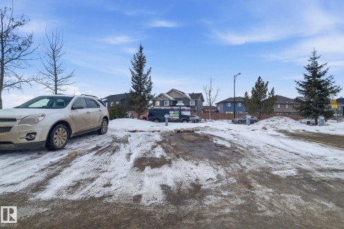 Yard layered in snow featuring a residential view - 424 1510 Watt Drive, Edmonton, AB - Outdoor