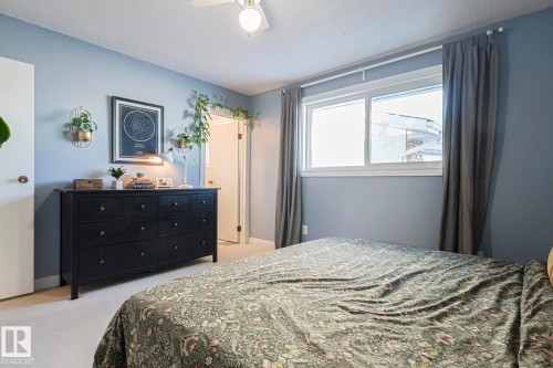 Bedroom featuring a ceiling fan, light colored carpet, and a textured ceiling - 192 Dunluce Road, Edmonton, AB - Indoor Photo Showing Bedroom