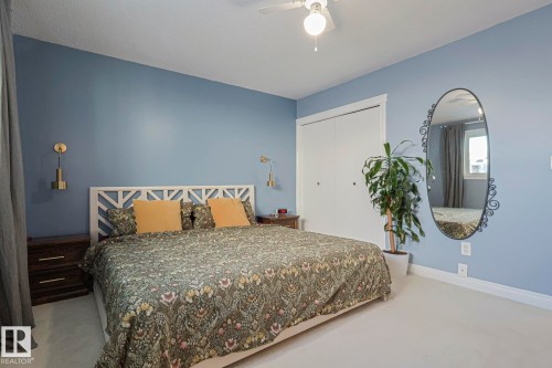 Bedroom featuring a closet, light carpet, and a ceiling fan - 192 Dunluce Road, Edmonton, AB - Indoor Photo Showing Bedroom