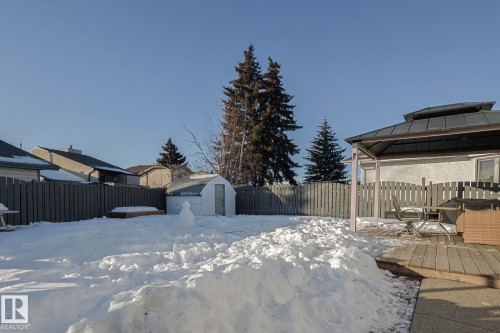 Fenced backyard with a wooden deck, a storage shed, and a gazebo - 192 Dunluce Road, Edmonton, AB - Outdoor