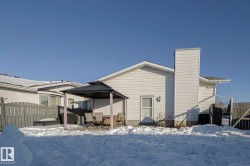 Snow covered property featuring a patio area, a gazebo, a chimney, and outdoor dining area - 