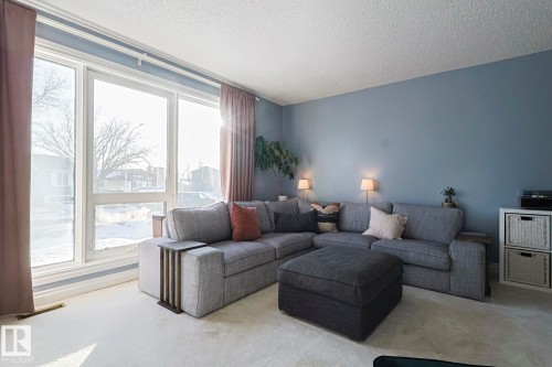 Living room featuring a textured ceiling and carpet - 192 Dunluce Road, Edmonton, AB - Indoor Photo Showing Living Room