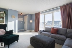 Living area with carpet flooring and a textured ceiling - 