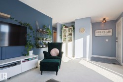 Living area with light colored carpet and baseboards - 