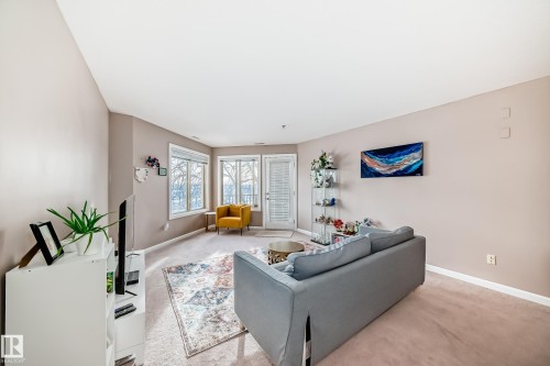 Carpeted living area featuring baseboards - 232 530 Hooke Road, Edmonton, AB - Indoor Photo Showing Living Room