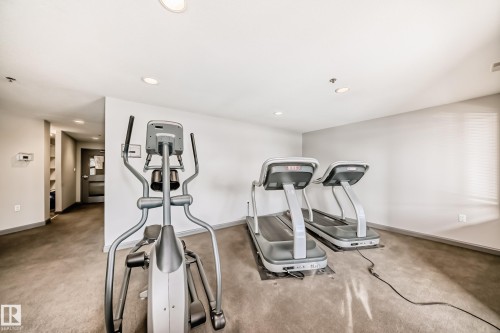 Exercise area with recessed lighting - 232 530 Hooke Road, Edmonton, AB - Indoor Photo Showing Gym Room