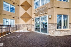 View of exterior entry featuring stone siding and stucco siding - 