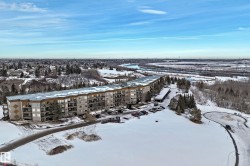 Snowy aerial view featuring a view of apartment building / complex - 