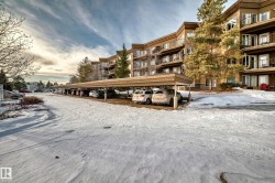 Snow covered property with a view of apartment building / complex - 