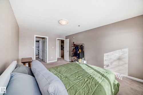 Carpeted bedroom featuring baseboards - 232 530 Hooke Road, Edmonton, AB - Indoor Photo Showing Bedroom